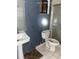 Bathroom with white toilet and pedestal sink at 1604 Royal Palm Dr, Edgewater, FL 32132