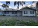 Ranch-style home with a spacious yard and mature trees at 1604 Royal Palm Dr, Edgewater, FL 32132