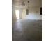Empty garage with concrete floor and open door at 1604 Royal Palm Dr, Edgewater, FL 32132