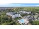Aerial view of community with pool and multiple buildings at 3176 Feltrim Pl # 102, Kissimmee, FL 34747