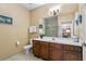 Bathroom features a vanity with wood cabinets, toilet and shower/tub combo at 3176 Feltrim Pl # 102, Kissimmee, FL 34747