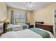 Bright bedroom with two twin beds and a window overlooking the backyard at 3176 Feltrim Pl # 102, Kissimmee, FL 34747
