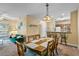 Charming dining area with wood table and chairs, and view into the kitchen at 3176 Feltrim Pl # 102, Kissimmee, FL 34747