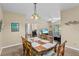 Bright dining room features a wood table with seating for six and a lovely chandelier at 3176 Feltrim Pl # 102, Kissimmee, FL 34747