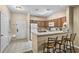 Kitchen with breakfast bar and three barstools at 3176 Feltrim Pl # 102, Kissimmee, FL 34747