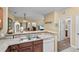 Kitchen with double sink, dishwasher, and view to living room at 3176 Feltrim Pl # 102, Kissimmee, FL 34747