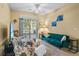 Spacious living room with a teal sofa and access to a private balcony at 3176 Feltrim Pl # 102, Kissimmee, FL 34747