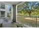 Private patio with small table and chairs, overlooks a lush green space at 3176 Feltrim Pl # 102, Kissimmee, FL 34747