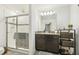 Bathroom with walk-in shower and dark vanity at 439 Annabelle Way, Davenport, FL 33837
