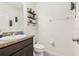 Clean and modern bathroom with dark vanity and shelving at 439 Annabelle Way, Davenport, FL 33837
