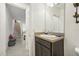 Small bathroom with dark vanity and view of staircase at 439 Annabelle Way, Davenport, FL 33837