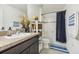 Clean bathroom with dark vanity, bathtub, and shower at 439 Annabelle Way, Davenport, FL 33837