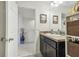 Well-lit bathroom with dark vanity and a view to another room at 439 Annabelle Way, Davenport, FL 33837