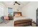 Bright bedroom with wood bed frame, window coverings, and ceiling fan at 439 Annabelle Way, Davenport, FL 33837