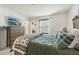 Bedroom with dresser, large window, and green bedding at 439 Annabelle Way, Davenport, FL 33837