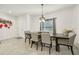 Bright dining area with a wooden table, six chairs, and a decorative light fixture at 439 Annabelle Way, Davenport, FL 33837