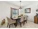 Elegant dining room with a dark wood table and six gray cushioned chairs at 439 Annabelle Way, Davenport, FL 33837
