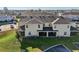 Rear view of townhouse with covered patio and AC units at 439 Annabelle Way, Davenport, FL 33837