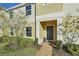 Front view of a two-story townhome featuring a gray door and well-maintained landscaping at 439 Annabelle Way, Davenport, FL 33837