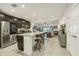 Modern kitchen with dark cabinetry, granite countertops, and stainless steel appliances at 439 Annabelle Way, Davenport, FL 33837