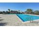 Community pool with adjacent patio and shaded seating area at 439 Annabelle Way, Davenport, FL 33837