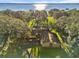 Bird's eye view of house on waterfront lot with mature trees at 5100 Helen Ct, St Cloud, FL 34772