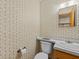 Small half bathroom with vintage wallpaper and updated toilet at 5100 Helen Ct, St Cloud, FL 34772