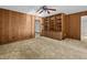 Bedroom with built-in shelving and wood paneled walls at 5100 Helen Ct, St Cloud, FL 34772
