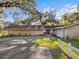Brick ranch house exterior with red front door and attached garage at 5100 Helen Ct, St Cloud, FL 34772
