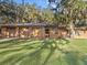 Three-car brick garage with a spacious lawn at 5100 Helen Ct, St Cloud, FL 34772