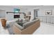 Living room with fireplace, staged furniture, and tile floors at 5100 Helen Ct, St Cloud, FL 34772