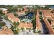 Aerial view of community with lake, pool, and buildings at 6141 Metrowest Blvd # 307, Orlando, FL 32835