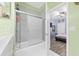 Bathroom with tub and shower, and view into the bedroom at 6141 Metrowest Blvd # 307, Orlando, FL 32835