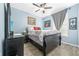 Well-lit bedroom with a comfortable bed, ceiling fan, and wood flooring at 6141 Metrowest Blvd # 307, Orlando, FL 32835