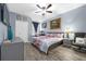 Spacious bedroom with a large bed, ceiling fan, and plenty of natural light at 6141 Metrowest Blvd # 307, Orlando, FL 32835