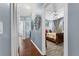 Hallway with wood flooring and doors to bedrooms at 6141 Metrowest Blvd # 307, Orlando, FL 32835