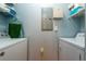 Laundry room with washer, dryer, and shelving at 6141 Metrowest Blvd # 307, Orlando, FL 32835