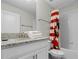 Bathroom with single vanity and Mickey Mouse shower curtain at 9022 Stinger Dr, Davenport, FL 33896
