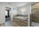 Spa-like bathroom featuring a soaking tub and walk-in shower at 9022 Stinger Dr, Davenport, FL 33896
