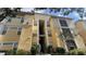 Visconti condo building, featuring a light yellow exterior and lush landscaping at 1150 Lake Shadow Cir # 3304, Maitland, FL 32751