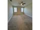 Spacious bedroom with carpeted floors and dual windows at 1222 Castlevecchio Loop, Orlando, FL 32825