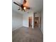 Bedroom with ceiling fan, carpet, and access to a hallway at 13565 Fountainbleau Dr, Clermont, FL 34711