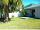 Backyard view with patio and palm trees at 1569 Thetford Cir, Orlando, FL 32824