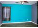 Spacious bedroom with teal walls and dark wood flooring at 1569 Thetford Cir, Orlando, FL 32824