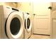 Bright laundry room with Whirlpool washer and dryer at 1569 Thetford Cir, Orlando, FL 32824