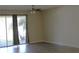 Living room with gray flooring, neutral walls, and sliding doors to patio at 1569 Thetford Cir, Orlando, FL 32824