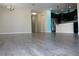 Living room with gray wood-look flooring and a view into the kitchen at 1569 Thetford Cir, Orlando, FL 32824