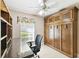 Home office with built-in desk, shelving, and cabinets at 169 Tall Pines Pass, Kissimmee, FL 34759