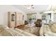 Living room with wood floors, plaid sofas and a ceiling fan at 169 Tall Pines Pass, Kissimmee, FL 34759