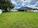 Large backyard with a spacious grassy area at 2867 Berkshire Cir, Kissimmee, FL 34743